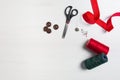 Sewing accessories on a white background, sewing threads and needles and scissors buttons Royalty Free Stock Photo