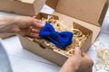sewing craft business - seamstress packing blue fabric bow tie in box for shipping