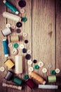 Sewing and craft tools - threads and buttons on wooden background in vintage style