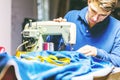 Sewing denim jeans with sewing machine. Repair jeans by sewing machine. Alteration jeans, hemming a pair of jeans, handmade Royalty Free Stock Photo