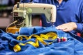 Sewing denim jeans with sewing machine. Repair jeans by sewing machine. Alteration jeans, hemming a pair of jeans, handmade Royalty Free Stock Photo