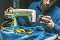 Sewing denim jeans with sewing machine. Repair jeans by sewing machine. Alteration jeans, hemming a pair of jeans, handmade Royalty Free Stock Photo