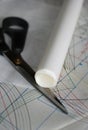 Sewing drawing, scissors and roll of tracing paper on the