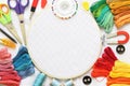 Sewing and embroidery kit with threads and needle, button, scissors and fabrics on frame Royalty Free Stock Photo