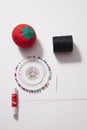 Sewing equipment with pin cushion and needle and red thread Royalty Free Stock Photo