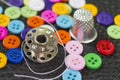 Sewing items - cloth buttons, thimble, needle, spools of thread Royalty Free Stock Photo