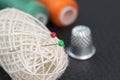 Sewing items - thimble, needle, measuring tape, spools of thread and pins Royalty Free Stock Photo