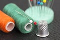 Sewing items - thimble, needle, spools of thread and pins Royalty Free Stock Photo