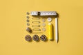 Sewing kit accessories and tools for needle work in yellow. Tape measure, pins, scissors, buttons, prewound bobbins, thimble, Royalty Free Stock Photo