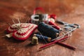 Sewing and knitting material on a rustic wooden table. Royalty Free Stock Photo