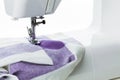 Sewing machine in action with fabric undergoing stitching process in a bright workshop Royalty Free Stock Photo