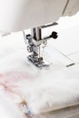 Sewing machine in action stitching fabric together at daytime craft session Royalty Free Stock Photo