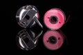 Bobbin case and plastic bobbin mirrored on black background Royalty Free Stock Photo