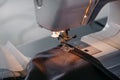 Sewing machine, close-up of a needle and black fabric. Royalty Free Stock Photo