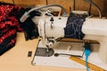 Sewing machine with colorful fabric and tools on a work table in a crafting space during the day Royalty Free Stock Photo