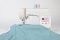 Sewing machine and colorful thread rolls, scissors, fabric and a Royalty Free Stock Photo