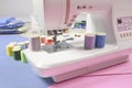 Sewing machine and colorful thread rolls for sewing on two tone Royalty Free Stock Photo
