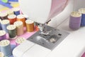 Sewing machine and colorful thread rolls for sewing on two tone Royalty Free Stock Photo