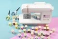 Sewing machine and colorful thread rolls for sewing on two tone Royalty Free Stock Photo