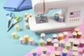 Sewing machine and colorful thread rolls for sewing on two tone Royalty Free Stock Photo