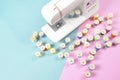 Sewing machine and colorful thread rolls for sewing on two tone Royalty Free Stock Photo