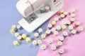 Sewing machine and colorful thread rolls for sewing on two tone Royalty Free Stock Photo