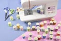 Sewing machine and colorful thread rolls for sewing on two tone Royalty Free Stock Photo