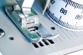 Sewing machine feet and a tailors tape measure Royalty Free Stock Photo