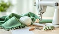 Sewing machine, green fabric and craft accessories on wooden table on light background Royalty Free Stock Photo