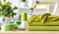 Sewing machine, green fabric and craft accessories on wooden table on light background Royalty Free Stock Photo