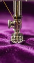 Sewing machine needle on purple fabric Royalty Free Stock Photo