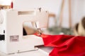 Sewing machine with red cloth closeup. sewing process in the re-stitching phase