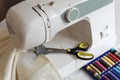 Sewing machine with scissors and sewing kit - reels of colour threads. Royalty Free Stock Photo