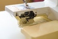 Sewing machine. Work by the light of the built-in hardware lamp. Steel needle with looper and presser foot close-up Royalty Free Stock Photo