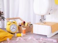 Sewing machine working with yellow fabric, sewing accessories on the table, stitch new clothing Royalty Free Stock Photo