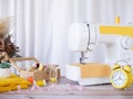 Sewing machine working with yellow fabric, sewing accessories on the table, stitch new clothing Royalty Free Stock Photo