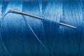 Sewing needle in blue thread bobbin Royalty Free Stock Photo