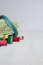 Sewing objects, threads, tape measure and tin box. Royalty Free Stock Photo