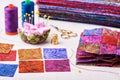 Sewing patchwork blocks to colorful batik quilt Royalty Free Stock Photo