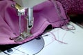 Sewing pink knitwear white sewing machine. Small business concept. Selective focus