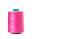 Sewing pink thread spool on a white background