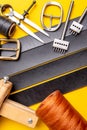 Sewing process of the leather belt. Tools, materials and accessories for leather workshop. Vintage sewing industrial Royalty Free Stock Photo