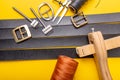 Sewing process of the leather belt. Tools, materials and accessories for leather workshop. Vintage sewing industrial Royalty Free Stock Photo