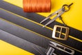 Sewing process of the leather belt. Tools, materials and accessories for leather workshop. Vintage sewing industrial Royalty Free Stock Photo