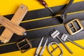 Sewing process of the leather belt. Tools, materials and accessories for leather workshop. Vintage sewing industrial Royalty Free Stock Photo