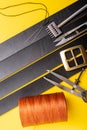 Sewing process of the leather belt. Tools, materials and accessories for leather workshop. Vintage sewing industrial Royalty Free Stock Photo