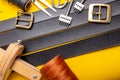 Sewing process of the leather belt. Tools, materials and accessories for leather workshop. Vintage sewing industrial Royalty Free Stock Photo