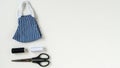 Banner, Sewing reusable and washable cotton mask during coronavirus or infection or allergy. Thread, scissors, and blue-and-white