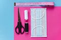 Sewing reusable and washable cotton mask during coronavirus or infection or allergy. Thread, scissors, measuring tape and blue-and