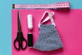 Sewing reusable and washable cotton mask during coronavirus or infection or allergy. Thread, scissors, measuring tape and blue-and